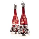 A SHEFFIELD PLATE-MOUNTED BOHEMIAN CRANBERRY GLASS DECANTER AND COASTER SET, 19TH CENTURY each