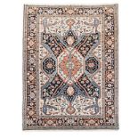 A HERIZ CARPET, NORTH WEST PERSIA, CIRCA 1950 the ivory field with a bold serrated indigo-blue,