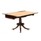 A REGENCY STYLE MAHOGANY PEMBROKE TABLE the rectangular top with hinged drop-sides above a frieze