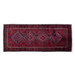 AN AFSHAR RUG, PERSIA, MODERN the red field with four stepped medallions depicted in black, ivory