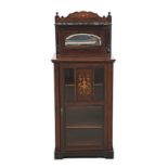 AN EDWARDIAN ROSEWOOD AND INLAID MUSIC CABINET the rectangular top surmounted by an arched and