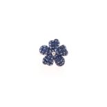 A SAPPHIRE RING in the form of a flower, the petals invisible-set with princess-cut sapphires