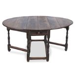 AN OAK GATE-LEG TABLE, 19TH CENTURY the rectangular top with hinged drop sides, above a frieze