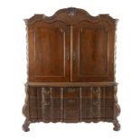 A DUTCH OAK ARMOIRE, 18TH CENTURY the gabled top centred by a leaf-carved keyblock above two