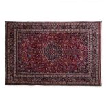 A MESHED CARPET, EAST PERSIA, MODERN the burgundy-red field with a black floral star medallion,