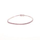 A PINK SAPPHIRE TENNIS BRACELET designed as a line of claw-set circular mixed-cut pink sapphires