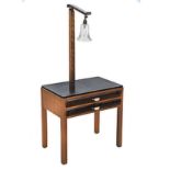 AN ART DECO EBONISED AND FRUITWOOD BEDSIDE TABLE the rectangular top surmounted by a bell-shaped
