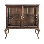 A CAPE STINKWOOD DISPLAY CABINET, 19TH CENTURY the rectangular plain top above a pair of glazed