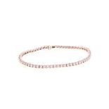 A DIAMOND TENNIS BRACELET, BROWNS designed as a line of sixty-four claw–set brilliant–cut diamonds