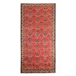 A HAMADAN CARPET, PERSIA, MODERN the red field with an overall palmette pattern depicted in blue,