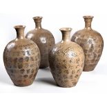 A GROUP OF FOUR CHINESE STONEWARE WATER VESSELS each of tapering ovoid form with everted neck, three