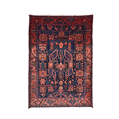 A HAMADAN RUG, WEST PERSIA, CIRCA 1960 the dark-blue field with a madder stylised floral skeleton