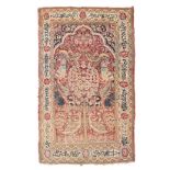 A KIRMAN PRAYER RUG, PERSIA, CIRCA 1930 the red mehrab with a multicoloured ascending design of a