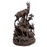 A 'BLACK FOREST' CARVED AND STAINED WOOD GROUP OF CHAMOIS, CIRCA 1900 depicting four chamois amongst