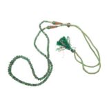 AN EMERALD NECKLACE composed of one strand of carved emerald beads, graduated in size, weighing