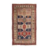 A KAZAK RUG, CAUCASIA, CIRCA 1930 the dark-blue field with four geometric medallions and guls within