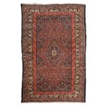 A BIDJAR RUG, WEST PERSIA, CIRCA 1950 the indigo-blue field with a madder-red and blue medallion,