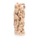 A JAPANESE IVORY OKIMONO OF AN IMMORTAL AND CHILDREN, MEIJI, 1868-1912 NOT SUITABLE FOR EXPORT