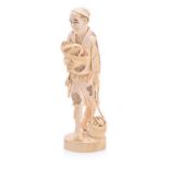 A JAPANESE CARVED IVORY OKIMONO OF A FARMER, MEIJI, 1868-1912 NOT SUITABLE FOR EXPORT the walking