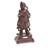 A CHINESE PATINATED BRONZE FIGURE OF A BOY IMMORTAL the standing figure wearing a flowing dhoti