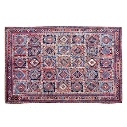 A YALAMEH CARPET, PERSIA, MODERN the red field divided into squares each holding multicoloured