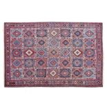 A YALAMEH CARPET, PERSIA, MODERN the red field divided into squares each holding multicoloured
