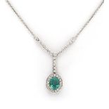 AN EMERALD AND DIAMOND PENDANT centred with an oval mixed-cut emerald weighing 1.68cts, within a