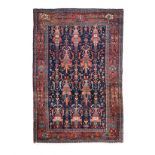 A KURDI RUG, WEST PERSIA, CIRCA 1960 the deep indigo-blue field with an overall design of vase and