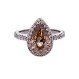 A DIAMOND RING centred with a pear-shaped Orange-Brown diamond weighing 3.02cts, the shoulders and