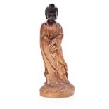 A CHINESE CARVED BOXWOOD AND ZITAN FIGURE OF GUANYIN wearing a long flowing robe, standing on a