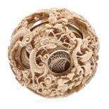 A LARGE CHINESE CARVED IVORY PUZZLE BALL, LATE 19TH CENTURY NOT SUITABLE FOR EXPORT densely carved