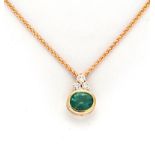 AN EMERALD AND DIAMOND PENDANT the surmount set with a trio of round brilliant-cut diamonds weighing