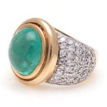 AN EMERALD AND DIAMOND DRESS RING, JENNA CLIFFORD centred with a bezel-set cabochon-cut emerald