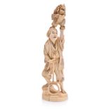 A JAPANESE CARVED IVORY OKIMONO OF AN ENTERTAINER, MEIJI, 1868-1912 NOT SUITABLE FOR EXPORT the