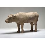 A CHINESE PAINTED POTTERY FIGURE OF A BULL, HAN, 206-220 standing at rest on its four feet, the head