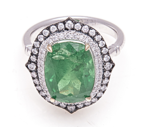 A TSAVORITE AND DIAMOND RING centred with a cushion-cut tsavorite weighing 7.739cts, within a double