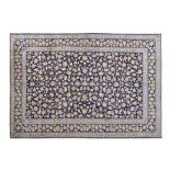 A KESHAN CARPET, PERSIA, MODERN the deep indigo-blue field with overall multicoloured palmettes,