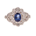 A SAPPHIRE AND DIAMOND RING centred with an oval mixed-cut sapphire weighing 0.76cts, within a