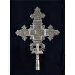 A PROCESSIONAL COPTIC CROSS, ETHIOPIA the cross pierced and centred by a cartouche inscribed with
