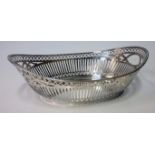 A DUTCH SILVER TWO-HANDLED BASKET, 1954, .833 STANDARD the pierced oval body with reeded rim,