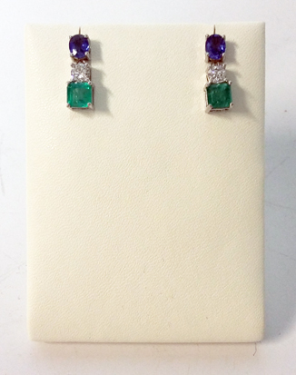 A PAIR OF SAPPHIRE, DIAMOND AND EMERALD PENDANT EARRINGS each surmount claw-set with an oval mixed-