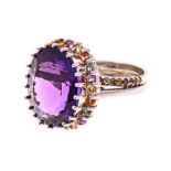 AN AMETHYST AND COLOURED GEM-STONES RING the band comprised of two overlapping teardrop shapes,