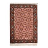 A CAUCASIAN RUG, CIRCA 1950 the ivory field with an overall trellis pattern enclosing floral
