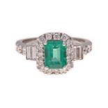 AN EMERALD AND DIAMOND RING centred with a claw-set emerald-cut emerald weighing approximately 1.