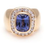 A TANZANITE AND DIAMOND RING, JENNA CLIFFORD centred with a bezel-set cushion mixed-cut tanzanite