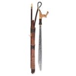 AN IBAN SWORD AND SCABBARD, BORNEO the carved bone handle stuffed with trophy hair, the scabbard