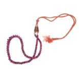 A RUBY NECKLACE composed of one strand of ruby beads, graduated in size, weighing approximately