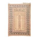 A TURKISH PRAYER RUG, KEYSERI, CIRCA 1960 the ivory mehrab with twin columns and central geometric