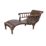 A FRUITWOOD LOUNGER, EARLY 20TH CENTURY the curved slatted base between carved arms on spindle