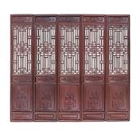 A CHINESE TEN PANEL FRUITWOOD SCREEN, QING DYNASTY each pierced geometric panel below a carved